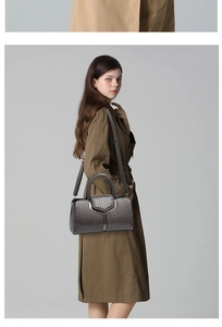 Detail of grey crocodile texture on a large crossbody handbag with metallic sheen