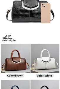 Detail view of crocodile textured handbags in black, brown, and white with phone for scale