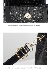 Detail of magnetic buckle closure and gold-plated hardware on black crocodile tote bag