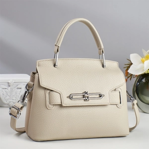 Detail of cream white leather pillow bag showing lychee grain and silver twist lock