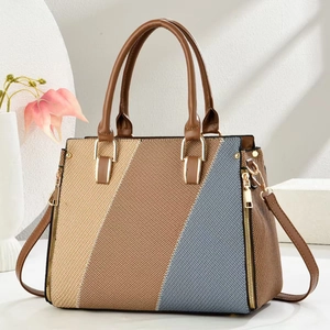 Modern color-block patchwork handbag with leather handles and gold hardware accents