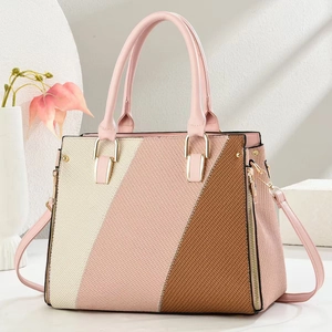Detail of tricolor patchwork handbag with textured stitching and gold metal buckles