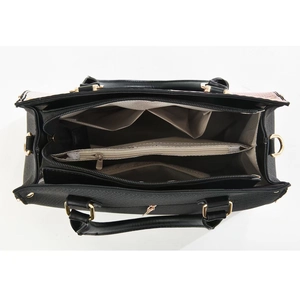 Top view of large contrast handbag showing multi-compartment interior and gold hardware