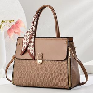 Elegant brown patchwork tote bag with woven texture and a stylish patterned silk scarf