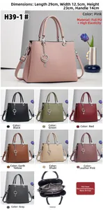 Detailed interior view of a multi-layer striped tote bag with a smiley charm and size info