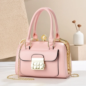 Detail of pink dinner bag with gold hardware, pearl clasp and chain shoulder strap