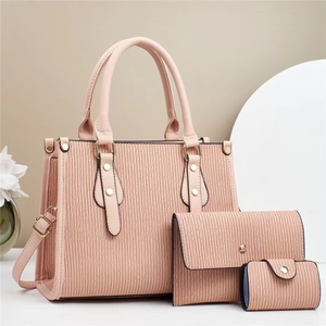 Detailed view of the wave-embossed textured leather bag 3-piece set in dusty rose
