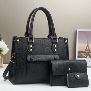 Detailed view of black 3-in-1 pebble grain bag set with gold rivets and hardware