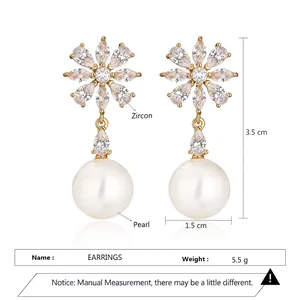 Elegant gold-plated daisy earrings with cubic zirconia petals and a large round pearl drop