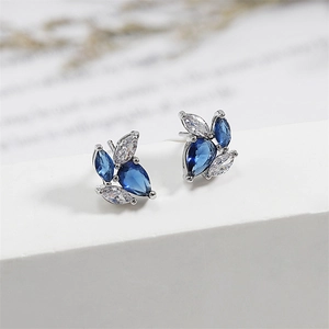Vintage French silver studs with blue and white zircon leaves on a minimal stand