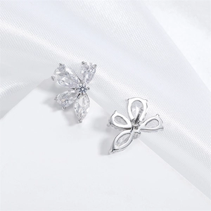 Elegant silver leaf stud earrings with marquise zircon stones on white silk backdrop