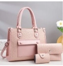 Three-piece pink embossed handbag set including tote, envelope clutch and small pouch
