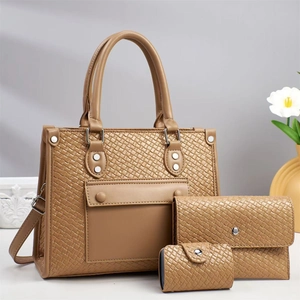 Detail view of tan woven texture tote bag set with matching wallet and card holder pieces