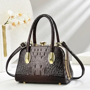 Brown crocodile textured handbag with crystal clasp and gold hardware for evening gala