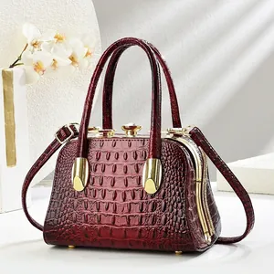 Elegant wine red crocodile pattern shell handbag with gold hardware and top handle