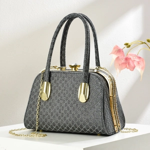 Detail of grey diamond-pattern evening bag with sparkling texture and gemstone clasp