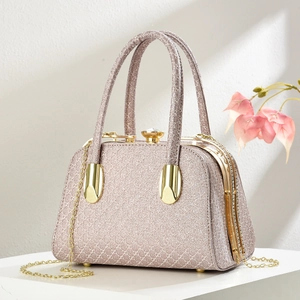 Detail of champagne glitter evening bag with geometric patterns and crystal clasp