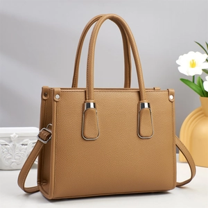 Brown lychee leather tote bag with silver U-shaped metal buckle and adjustable strap