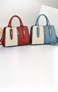 Close-up of contrast-color tote bag featuring diamond quilting and metallic zip details