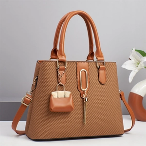 Brown woven pattern tote bag with smooth leather straps and mini decorative pouch