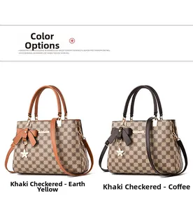 Detail view of checkered handbags with leather handles and decorative bow charms