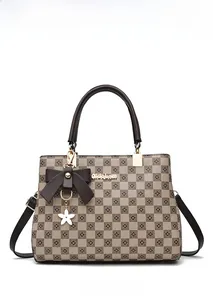 Detailed front view of checkerboard tote bag with bow pendant and gold nidebam logo