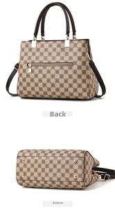 Detail view of the checkered tote bag showing rear zipper pocket and metal bottom studs