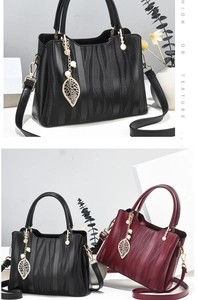 Detail of elegant wave pattern texture on black and burgundy faux leather handbags