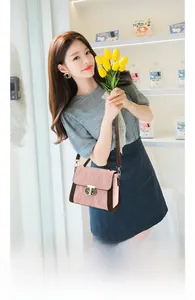 Detail of petal hardware on elegant grey-pink leather shoulder bag for commuting
