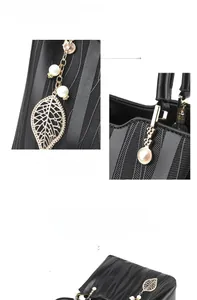 Detail view of wave pattern handbag with gold leaf pendant and pearl charm accessories