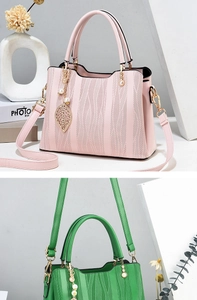 Detail of pink and green wave texture handbags with pearl leaf pendant and gold hardware