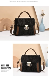 Detail of black pleated texture with brown leather handles and metallic D lock