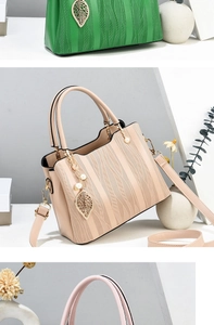 Detail of elegant wave pattern handbags with pearl and golden leaf charm pendants
