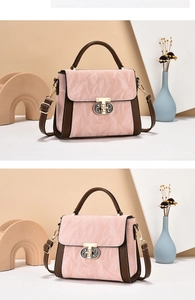 Detail of pink pleated leather and brown sides with interlocking gold metal clasp