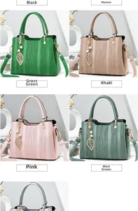 Detail of elegant wave-patterned tote bags in multiple colors with leaf pendants