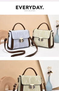 Detail of vintage tote bag with marble texture, metal ring buckle and crossbody strap