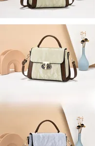 Detailed view of textured PU leather handbags with metal buckles and adjustable straps