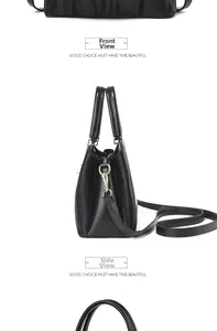 Detailed close-up of black wave-embossed leather handbag with gold hardware and side D-ring