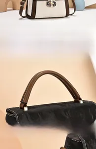 Detailed close-up of textured leather stitching and vintage gold hardware on the bag