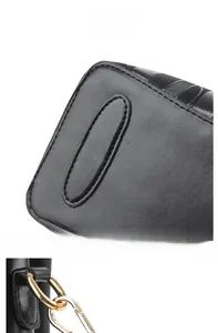 Detail view of wave pattern handbag featuring gold-tone hardware and protective bottom base