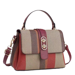 Chic burgundy striped tweed handbag with golden capsule lock and adjustable strap