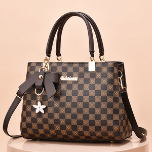 Vintage checkered handbag with bow charm and floral detail in rich brown tones