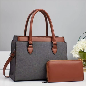 Close-up of brown leather and gray fabric tote bag with matching zipper wallet