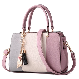 Chic tricolor leather handbag with cat pendant and lychee texture for stylish women