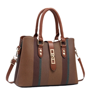 British style striped woven tote bag with brown leather accents and gold twist lock