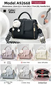 Litchi pattern leather tote with detachable geometric strap and plush pompom charm