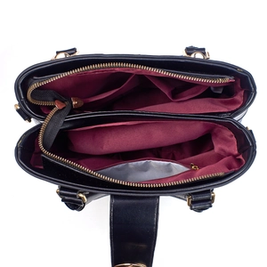 Detailed interior of lizard pattern handbag showing dual compartments and gold zippers