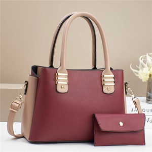 Détail du sac à main en cuir grainé bordeaux et beige avec son petit portefeuille