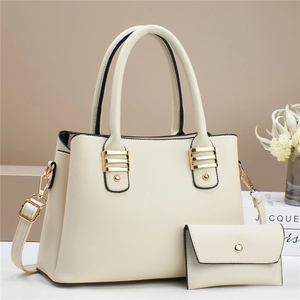 Elegant cream textured leather tote bag set with golden hardware and shoulder strap