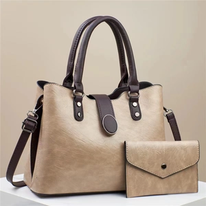 Detail view of champagne PU leather tote bag and matching wallet set with brown contrast trim